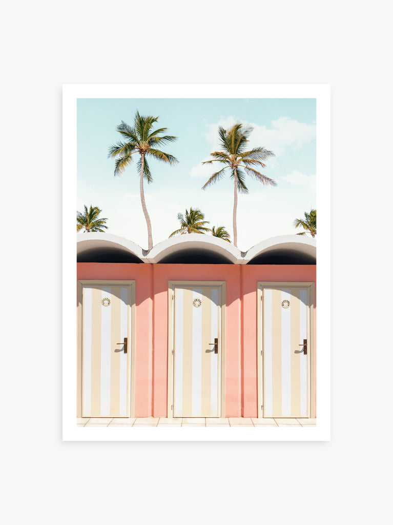 A print featuring a pair of pastel beach doors with a tropical background, including palm trees and a clear blue sky, fine art photograph by Paul Fuentes.