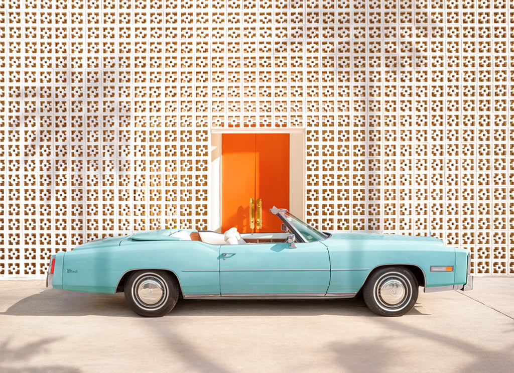 Art print of a light blue Cadillac parked in front of The Parker hotel in Palm Springs with the iconic breezy block wall, fine art photograph by Paul Fuentes.