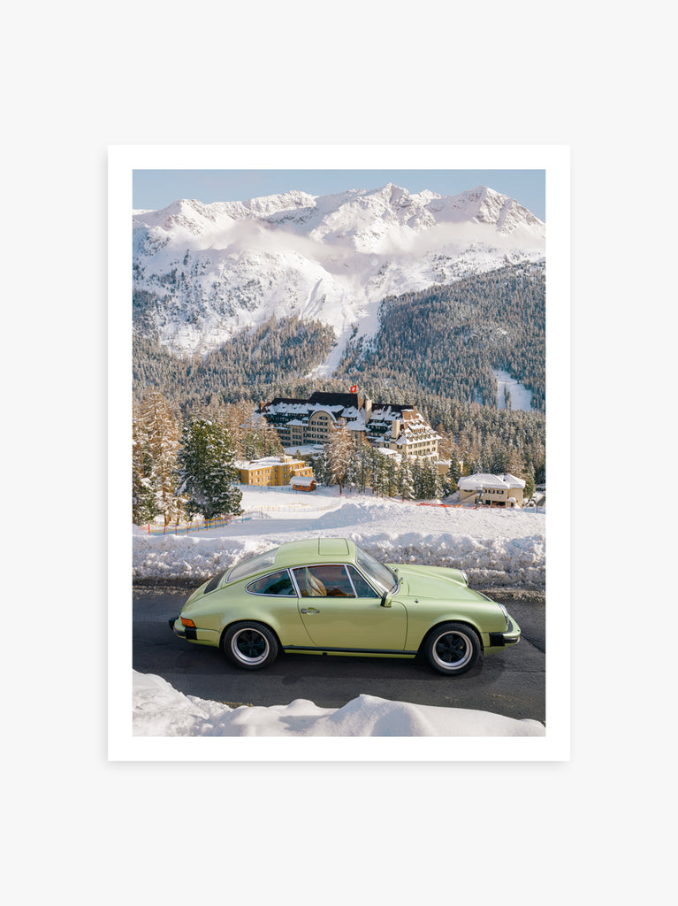 artwork of A classic Porsche driving through the alpine roads of St. Moritz, with the iconic Survetta Hotel and mountain landscape in the background. fine art print by Paul Fuentes.