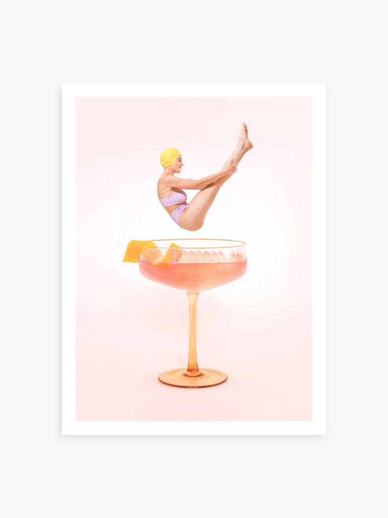 Cosmopolitan art print by Paul Fuentes with a vintage lady diving into a  a oversized cocktail glass, set against a pink background. 