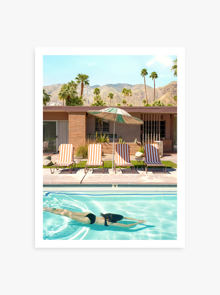 Woman diving into a turquoise Palm Springs pool, fine art photography by Paul Fuentes.