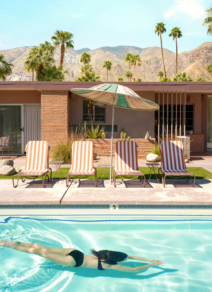 Woman diving into a turquoise Palm Springs pool, fine art photography by Paul Fuentes.