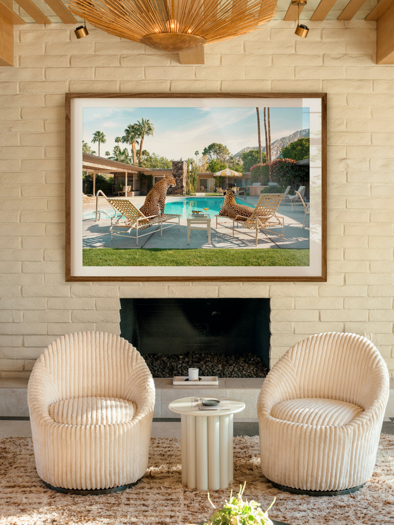framed artwork of two leopards lounging poolside in a Slim Aarons–inspired scene, fine art photography by Paul Fuentes.