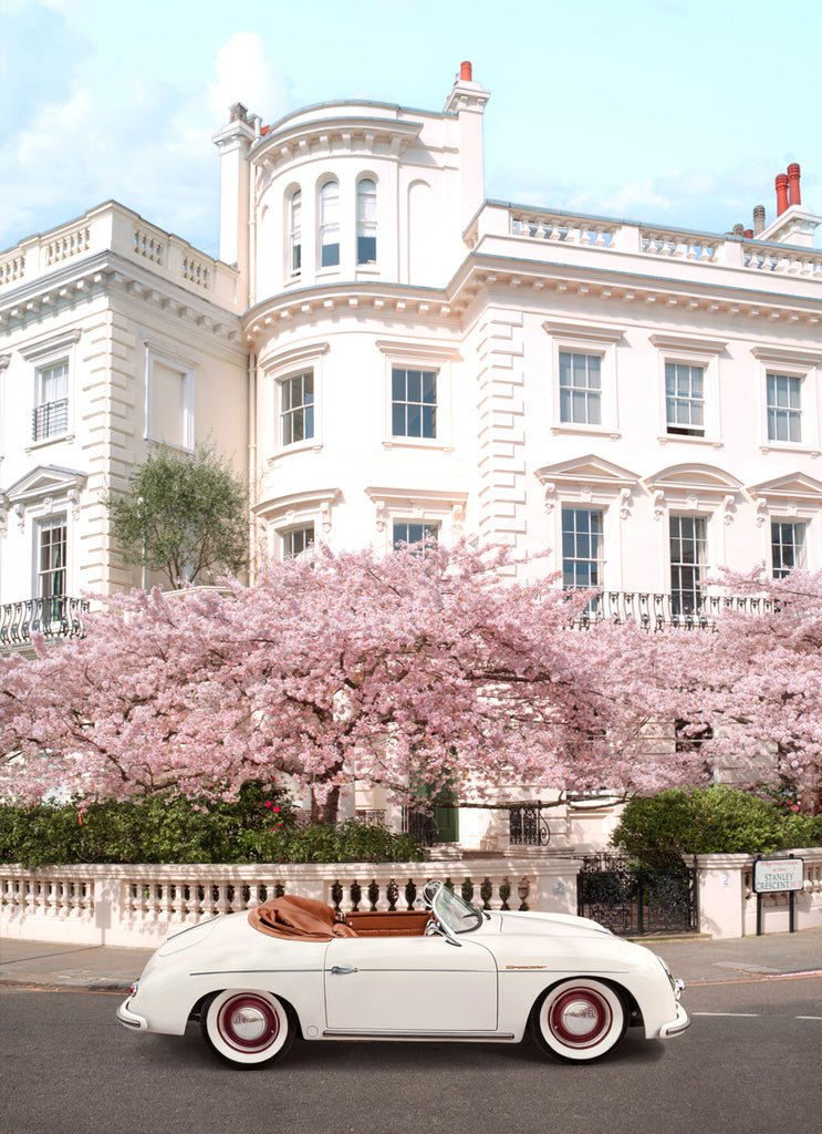 fine art photography by Paul Fuentes featuring a classic porche car in a london street with cherry blossoms in the background.
