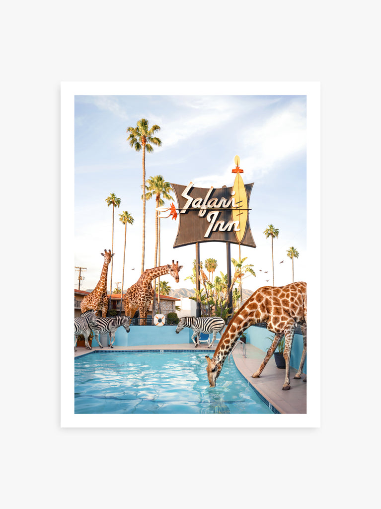 Classic motel with neon Safari Inn sign, where giraffes and zebras drinking from the pool, fine art photography by Paul Fuentes.