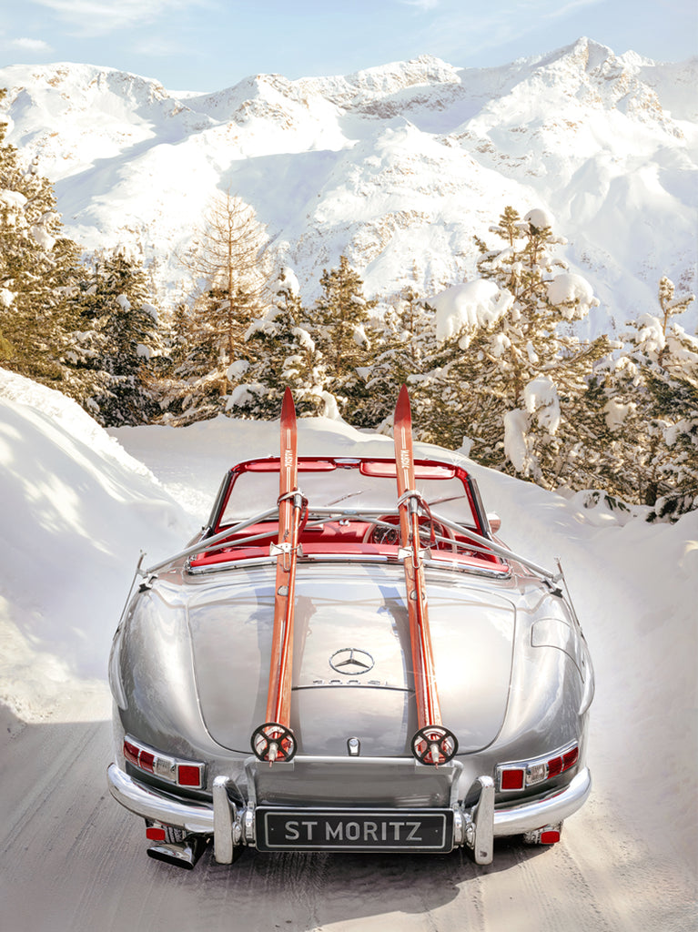 photograph of a Mercedes-Benz 300SL car with skis on the roof, set against a snowy mountain backdrop in St. Moritz, fine art print by Paul Fuentes.