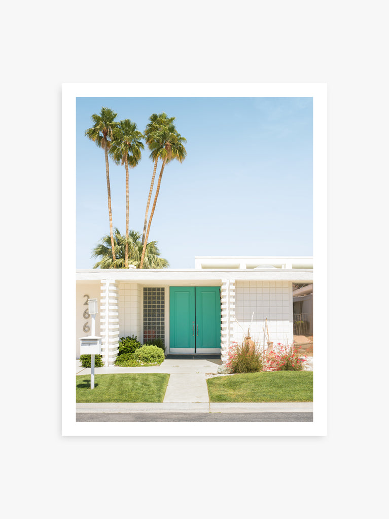 A printed image featuring a turquoise front door set against a palm tree backdrop in Palm Spring by fine art photographer Paul Fuentes