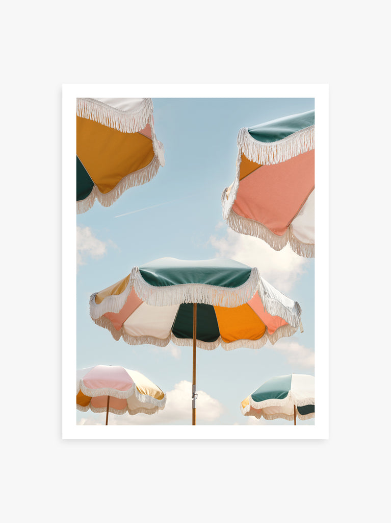 Colorful beach umbrellas from Business & Pleasure under a bright blue sky, fine art photography by Paul Fuentes.