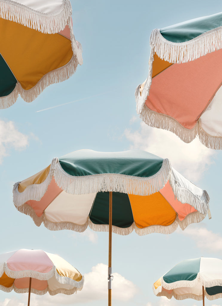 Colorful beach umbrellas from Business & Pleasure under a bright blue sky, fine art photography by Paul Fuentes.