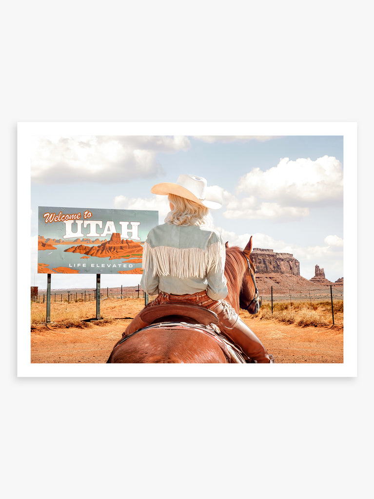 Art print by Paul Fuentes featuring a cowgirl on horseback with a 'Welcome to Utah' sign in the background, set against a desert landscape.