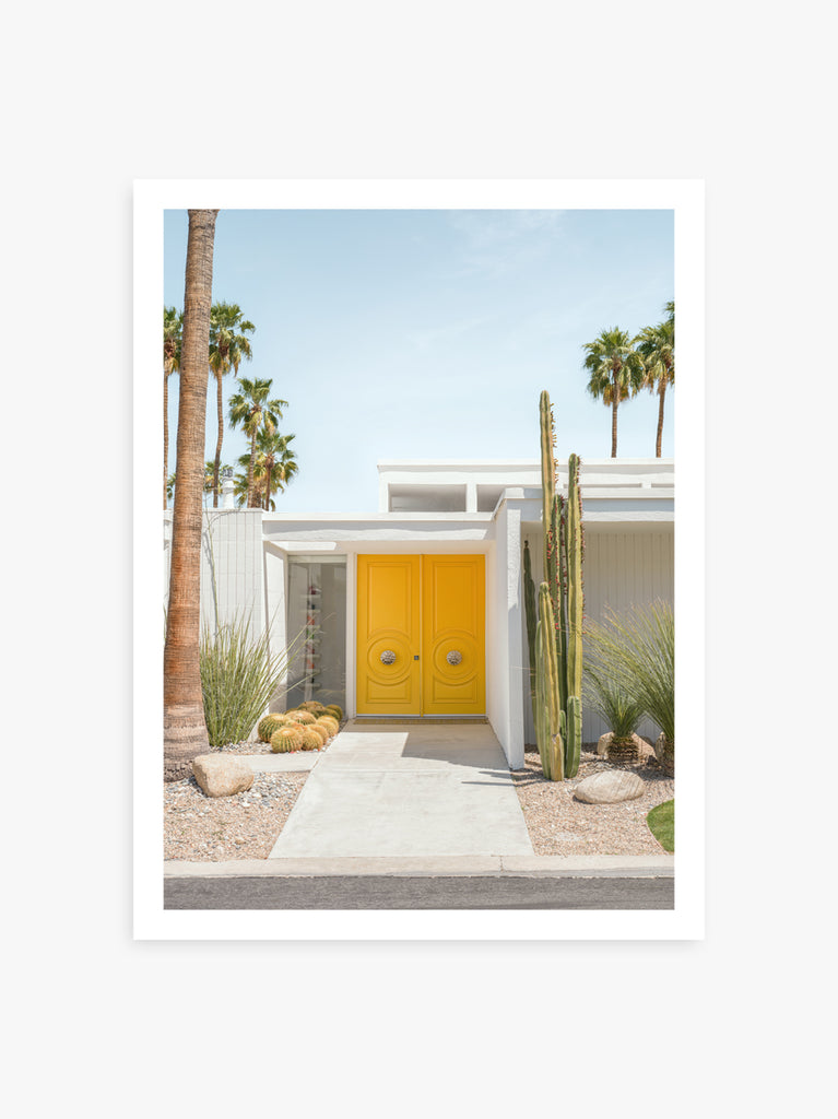 An art print of a vibrantly colored door with a modern design, set against a backdrop of palm trees and a cactus, reflecting a mid-century aesthetic in Palm Springs by Paul Fuentes 