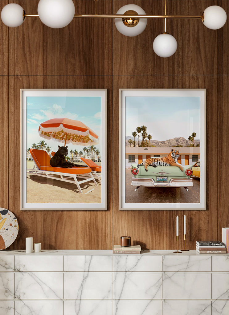 Framed artwork in mid century home  of of a Tiger on top of a classic car in front of a  roadside motel  and a black puma in Palm Springs, California, surreal fine art prints by Paul Fuentes. 