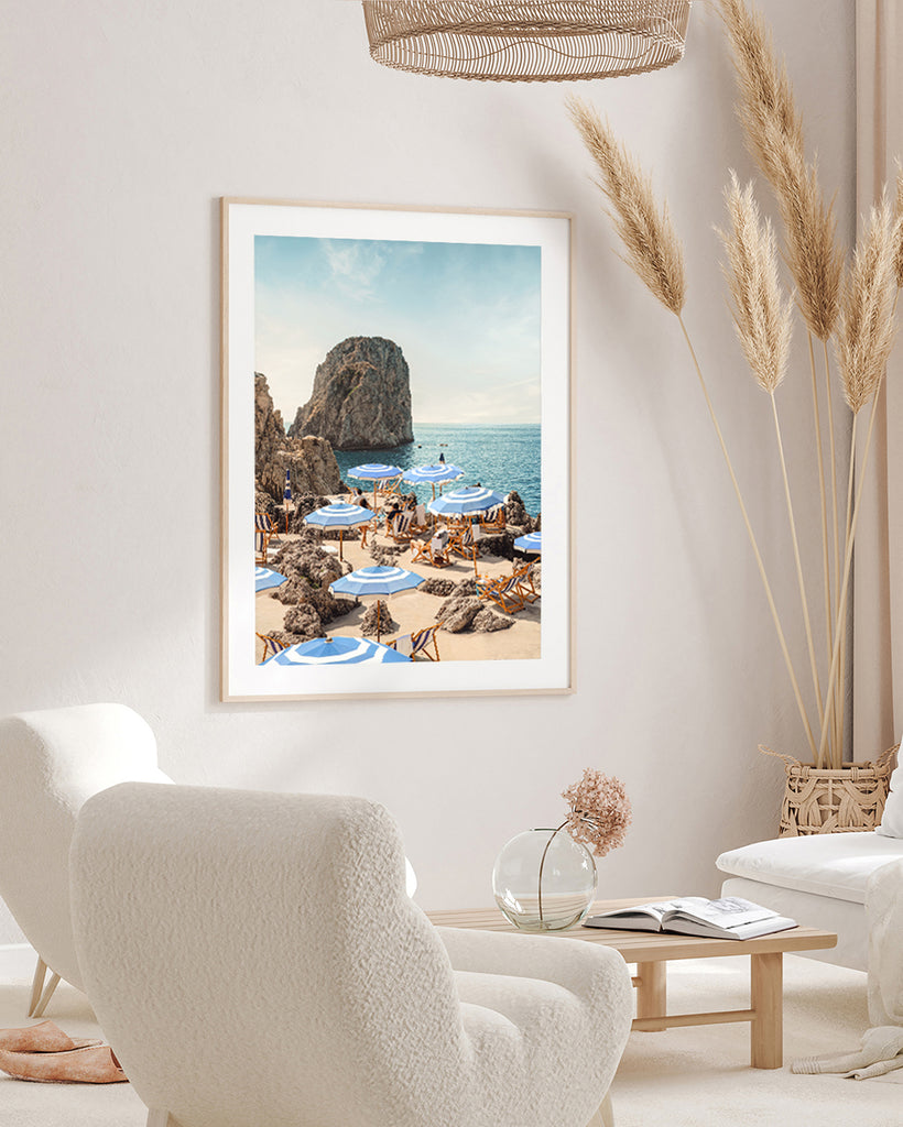 Framed Artwork of Capri beach scene with blue and white umbrellas and turquoise sea, fine art photograph by Paul Fuentes.