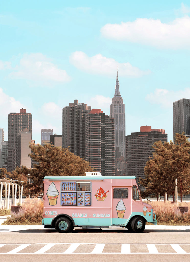 art print of pink ice cream truck on a new york city street with a skyline and empire state buidling in the background, fine art photography by paul fuentes