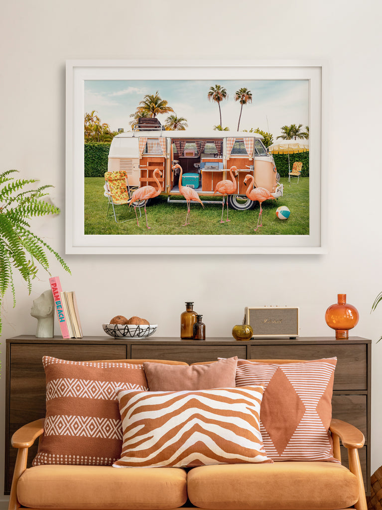 Framed wall art by Paul Fuentes of flamingos camping in a classic volkswagen van with tropical vibes.