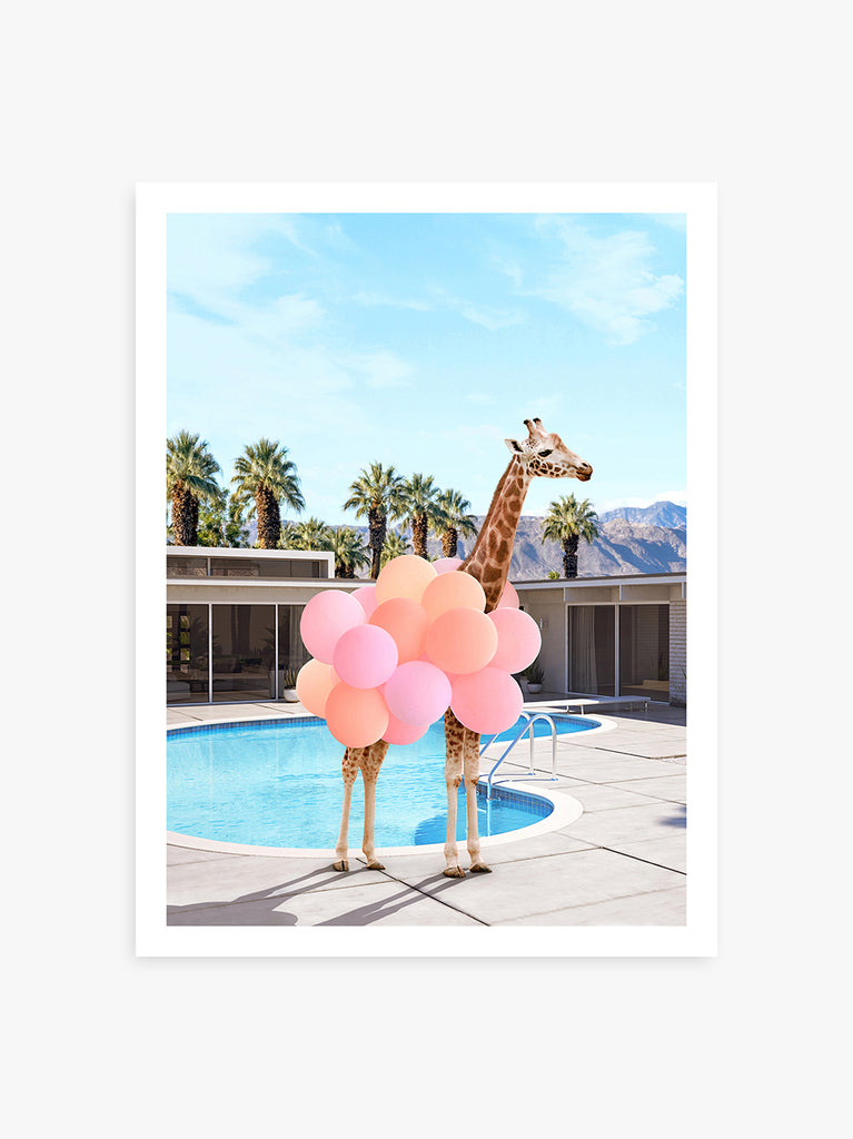 art print of a Giraffe dressed in balloons standing beside a Palm Springs home, fine art photograph by Paul Fuentes.