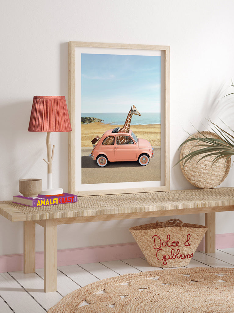framed artwork of a Giraffe sitting in a vintage car driving through Italy, fine art photography by Paul Fuentes.