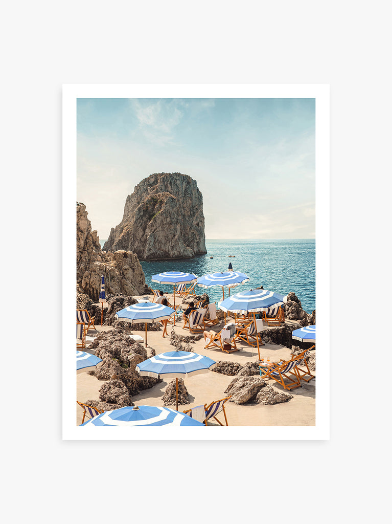 Capri beach scene with blue and white umbrellas and turquoise sea, fine art photograph by Paul Fuentes.