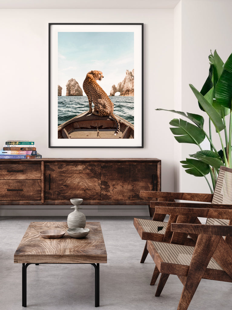 framed artwork of a Cheetah standing on a boat in Los Cabos  with the rocks, fine art photography by Paul Fuentes.