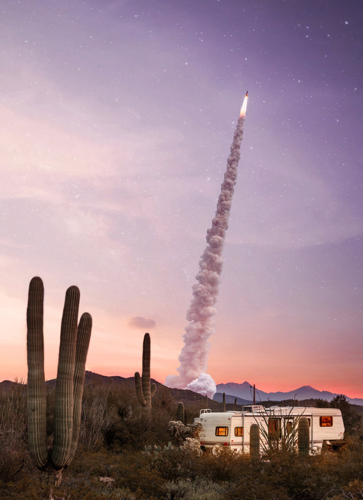 Caravan and rocket in the Mojave Desert with purple sky, fine art photography print by Paul Fuentes.