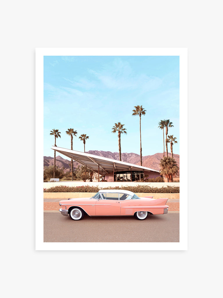 Classic pink Cadillac parked by a Palm Springs mid-century home, fine art photography by Paul Fuentes.