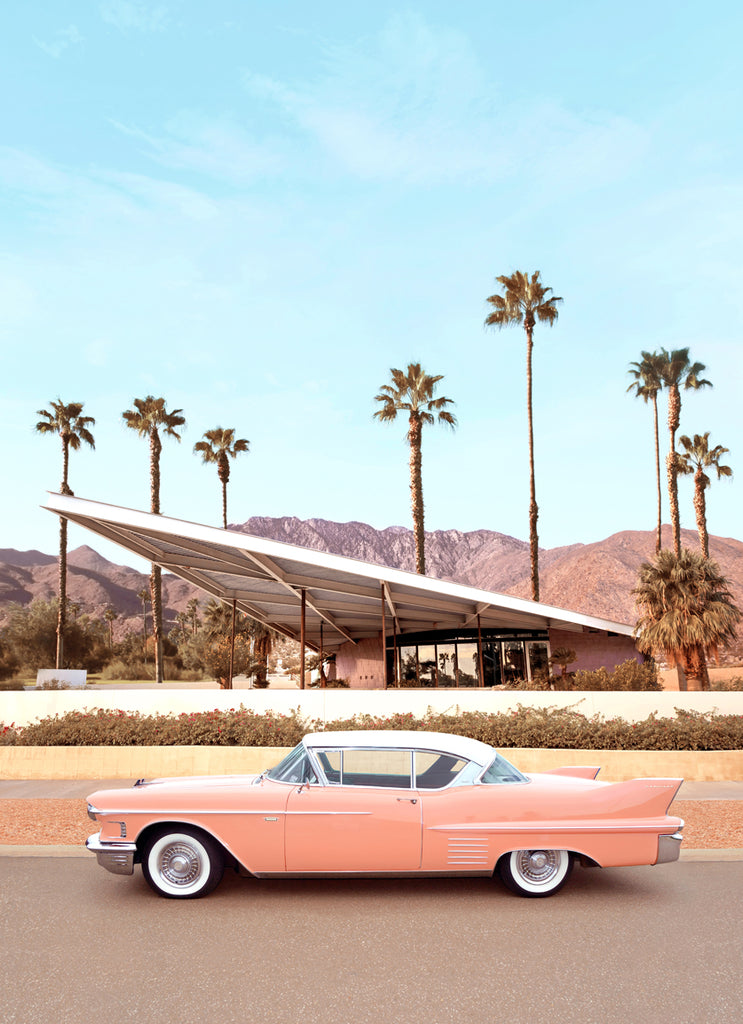 Classic pink Cadillac parked by a Palm Springs mid-century home, fine art photography by Paul Fuentes.