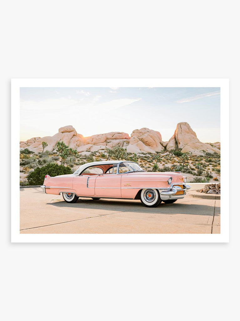Pink Cadillac parked in pastel desert landscape, fine art photography by Paul Fuentes.