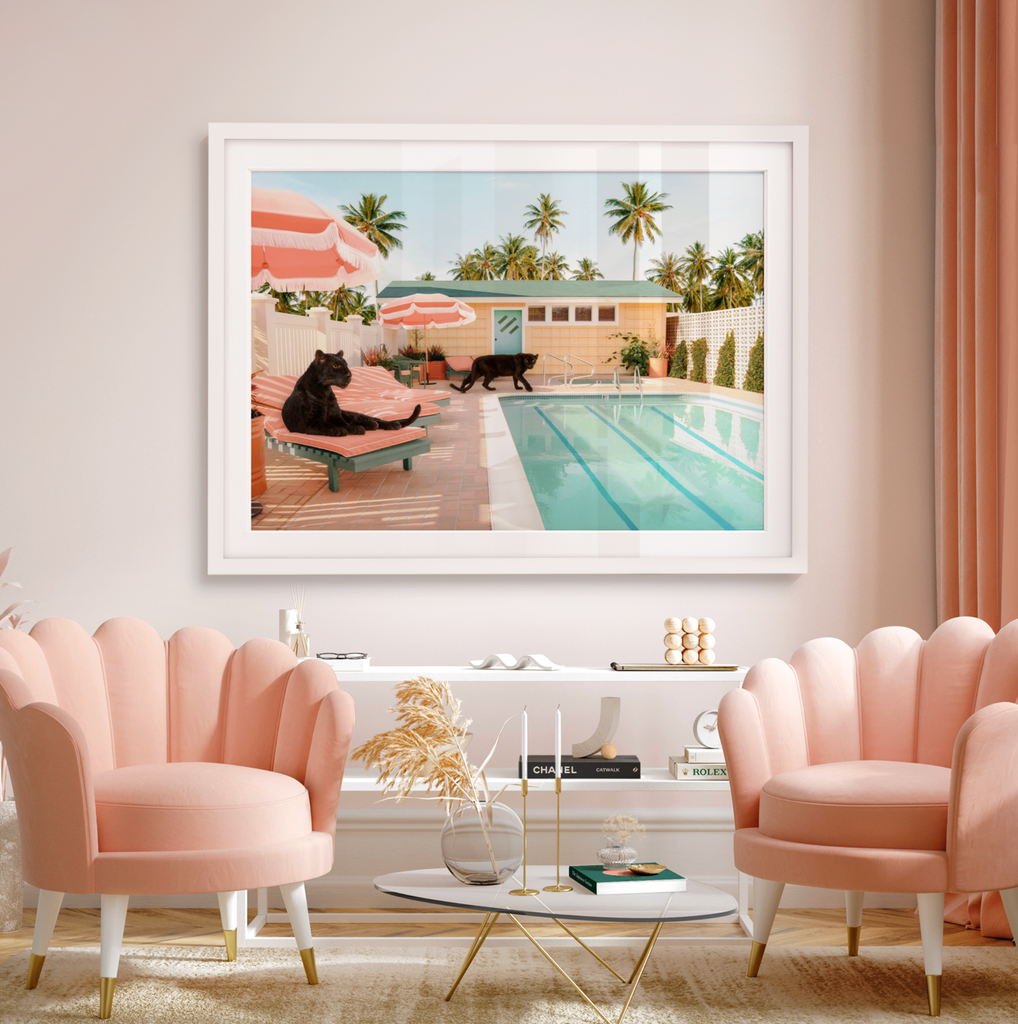 framed artwork of two black panthers resting beside a modern pool, pastel colors, fine art photography by Paul Fuentes.