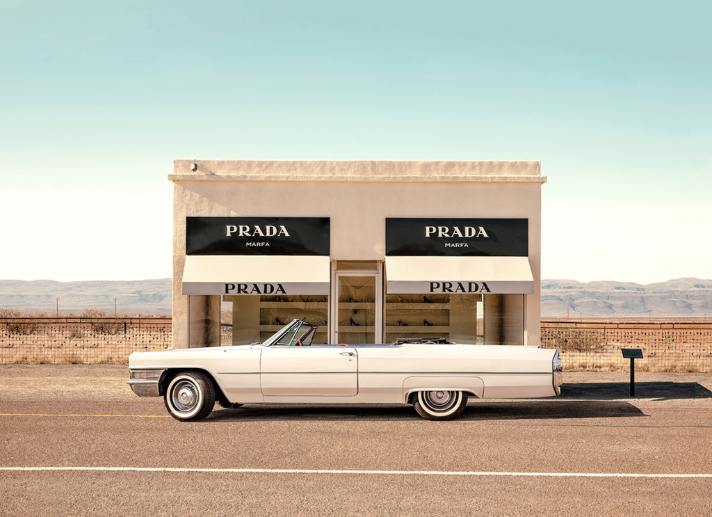 Classic car parked near Prada Marfa sculpture in Texas desert, fine art photography by Paul Fuentes.