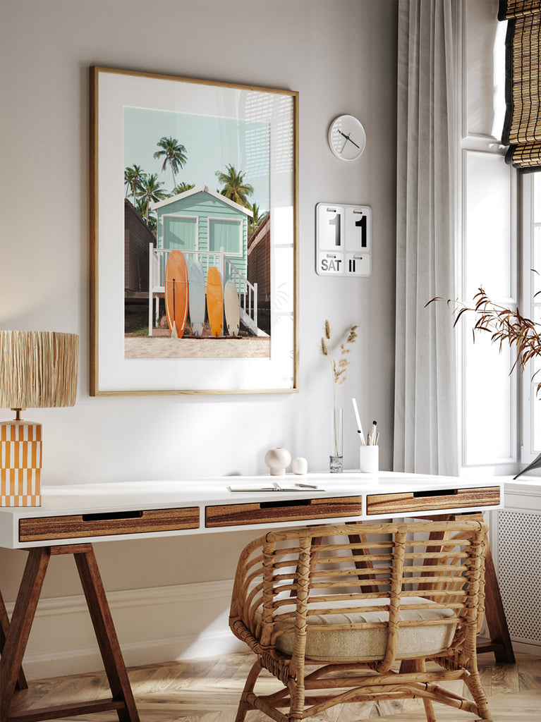 Framed wall art by Paul Fuentes showing a pastel green beach hut with surfboards leaning against it, set against a tropical backdrop with palm trees.