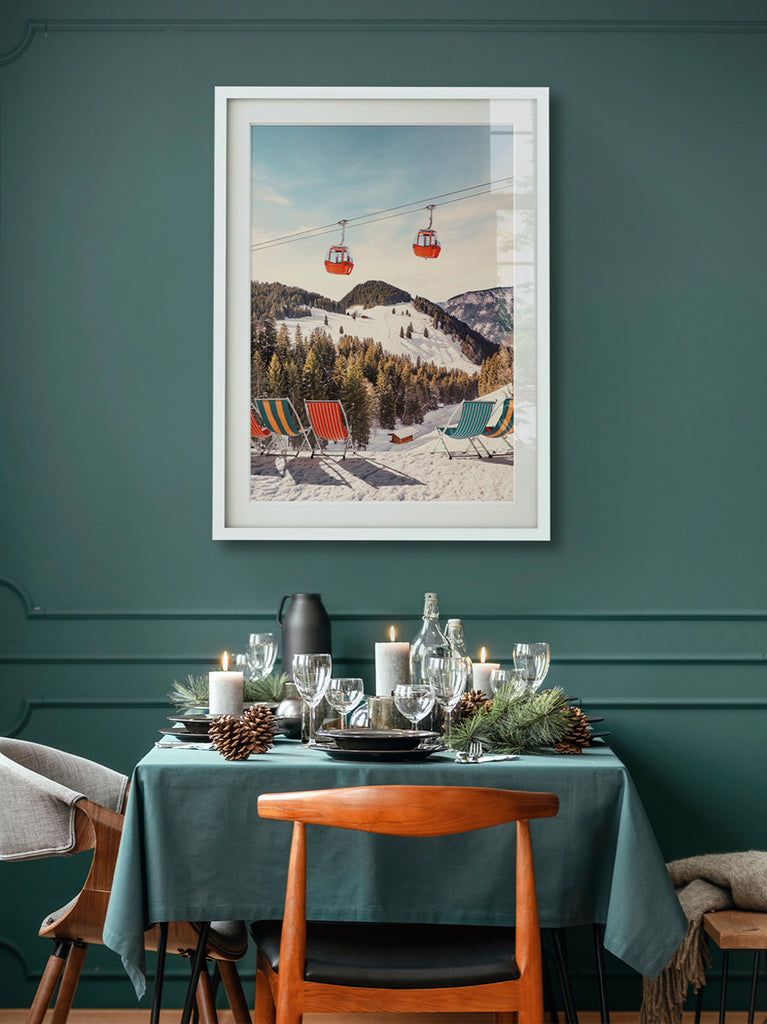 Framed artwork representation of luxurious winter chairs with a snowy mountain landscape in the background, including ski lifts and a clear blue sky. fine art photography by Paul Fuentes.